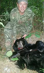 Hunter with a harvested black bear