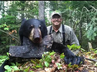 Hunter with a harvested black bear