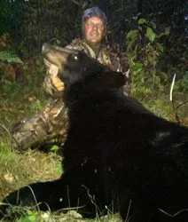 Hunter with a harvested black bear