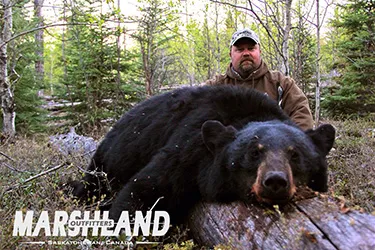 Hunter with a harvested black bear