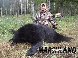 Hunter with a harvested black bear
